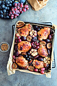 Roast chicken thighs with plums, grapes and garlic