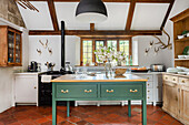 Country kitchen with green kitchen island and rustic wood decor