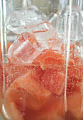 Melons in a blender with ice cubes