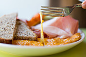 Cheese omelette with brown bread, vegetables and boiled ham