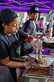 Workers preparing food at vegan food festival