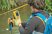 Man measuring river flow