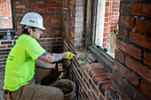 Worker laying bricks