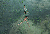 Boys playing in floodwater, Chittagong, Bangladesh