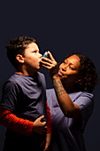 Boy using inhaler