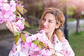 Woman admiring cherry blossom