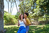 Happy lesbian couple playing on swing