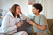 Happy lesbian couple drinking coffee