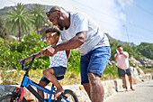 Father teaching son to ride a bike