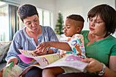 Lesbian couple and son reading
