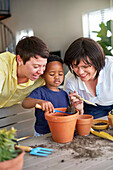 Family planting plants in flowerpots