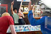 Young couple celebrating foosball victory