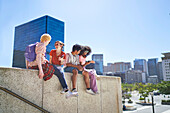 Young friends hanging out on ledge