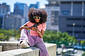 Young woman with headphones using smart phone