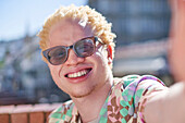 Young albino man smiling