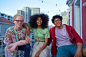 Young friends on urban apartment balcony