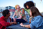 Young friends hanging out on urban balcony