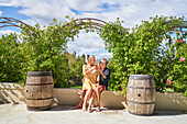 Senior couple drinking cocktails under trellis