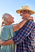 Senior couple hugging on balcony