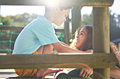 Sister and brother with Down syndrome at top of sunny slide