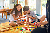 Sister and brother with Down syndrome playing with toys