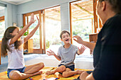 Boy with Down syndrome playing on floor with family