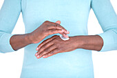 Woman applying hand cream