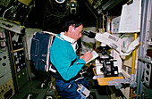Mamoru Mohri with microscope in Spacelab-J, STS-47