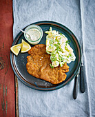 Breaded chicken schnitzel with potato and cucumber salad