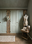 Rustic bedroom with wooden floor, wardrobe and dressmaker's dummy