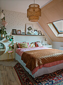 Attic bedroom with Scandinavian design, rug and rattan lamp