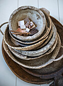 Stack of various baskets and bowls made from natural materials