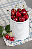 Red cherry in a white ceramic jar