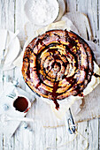 Giant skillet chocolate and cinnamon spiral with chocolate sauce and vanilla ice-cream