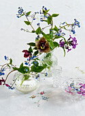 Vases with spring flowers on an embroidered tablecloth