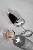 Roséweinglas und umgekipptes Rotweinglas