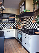 Kitchen with black and white chequered tiles and wooden flooring