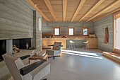 Modern living room with concrete walls and wooden ceiling