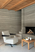 Modern living area with concrete walls and fireplace