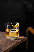 Whiskey with ice on wooden table
