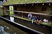 France,Eure,old wash-house of Sainte Colombe prés Vernon,Allied Reconstitution Group (US World War 2 and french Maquis historical reconstruction Association),the reenactors showing three women washing clothes in the washhouse in the 1940s