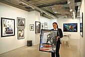 France,Paris,Royal Monceau hotel,Julie Eugene,art concierge of Royal Monceau,with a contemporary photo in arms at Art Photo Expo,the contemporary art gallery of the hotel