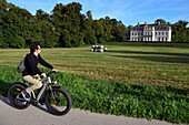 France,Seine-Maritime,Norman Seine River Meanders Regional Nature Park,Sahurs,chateau de Trémauville and cyclist on the veloroute of the Val de Seine