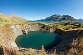 France,Savoie,Haute Maurienne,Val Cenis,Mont Cenis Pass,dam lake and concretions of gypsum,a funnel of dissolution created a small lake