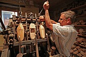 France,Haut Rhin,Lutterbach,sabotery Andre Haeberle,shoe maker Andre Haeberle at work,demonstration commented in front of visitors,his shoes are made of maple wood