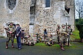 France,Eure,Chambray,Allied Reconstitution Group (US World War 2 and french Maquis historical reconstruction Association),reenactors in uniform of the 101st US Airborne Division and partisans of the French Forces of the Interior (FFI) resting in front of the church