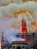 [ Unpublished - Exclusive ] France,Paris,area listed as World Heritage by UNESCO,Notre Dame Cathedral of 14th century Gothic architecture during the fire of 15th April 2019,close-up on the broken arrow,thick smoke yellow from the burning of lead