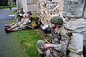 France,Eure,Chambray,Allied Reconstitution Group (US World War 2 and french Maquis historical reconstruction Association),reenactors in uniform of the 101st US Airborne Division resting in front of the church