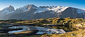 France,Hautes Alpes,the Grave,on the plateau of Emparis panoramic view of the Black Lake facing the massif of Meije at sunrise