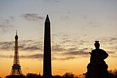 France,Paris,area listed as World Heritage by UNESCO,Place de la Concorde,a statue representing one of the main cities of France,the Eiffel Tower and the Obelisk at sunset